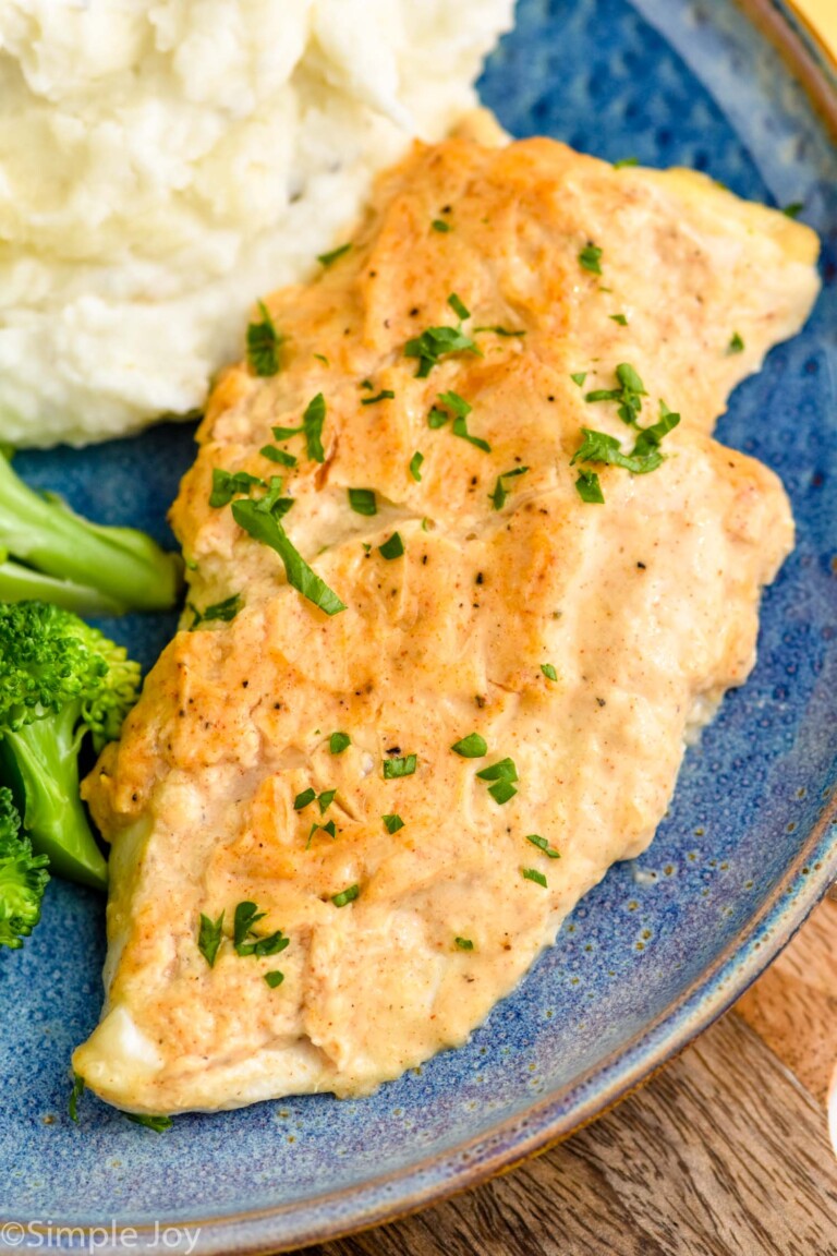 Close up view of Melt In Your Mouth Chicken served on a plate with mashed potatoes and broccoli