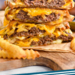 Pinterest graphic for Patty Melt. Image shows a stack of patty melt sandwiches with french fries sitting in front. Text says "patty melt simplejoy.com"