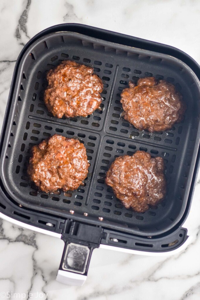 Overhead view of air fryer basket with Air Fryer Burgers