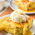 Pinterest graphic for Bread Pudding recipe. Text says, "the best Bread Pudding simplejoy.com" Image shows a piece of Bread Pudding served on a plate topped with Bread Pudding sauce and a scoop of ice cream. Fork beside with bite of Bread Pudding.