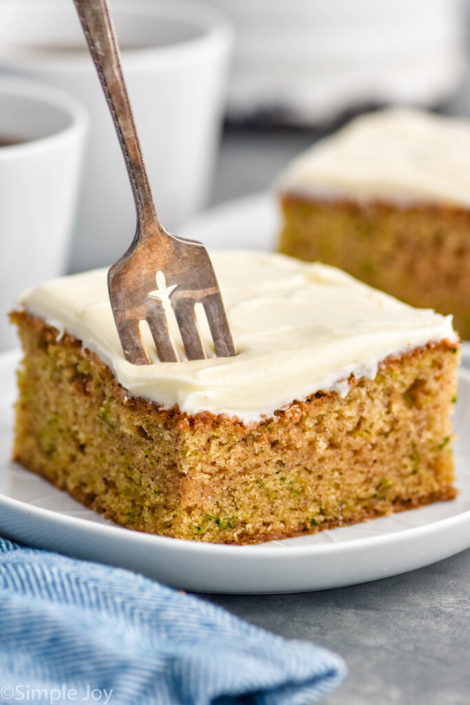 Slice of Zucchini Cake served on a plate with a fork
