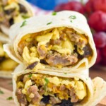 Breakfast Burrito cut in half with filling of eggs, cheese, sausage, and mushrooms