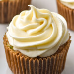 a cupcake with a swirl of cream cheese frosting on it