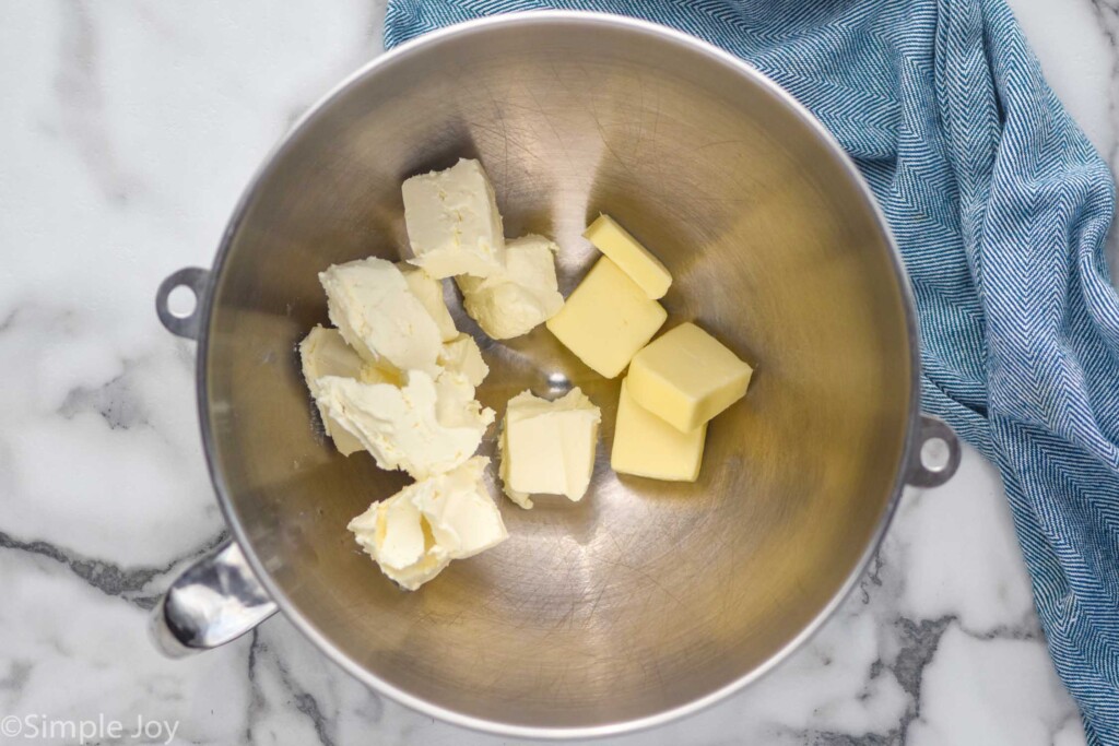 overhead of a mixing bowl with butter and cream cheese in it