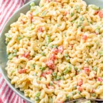 Bowl of Macaroni Salad with two spoons for serving