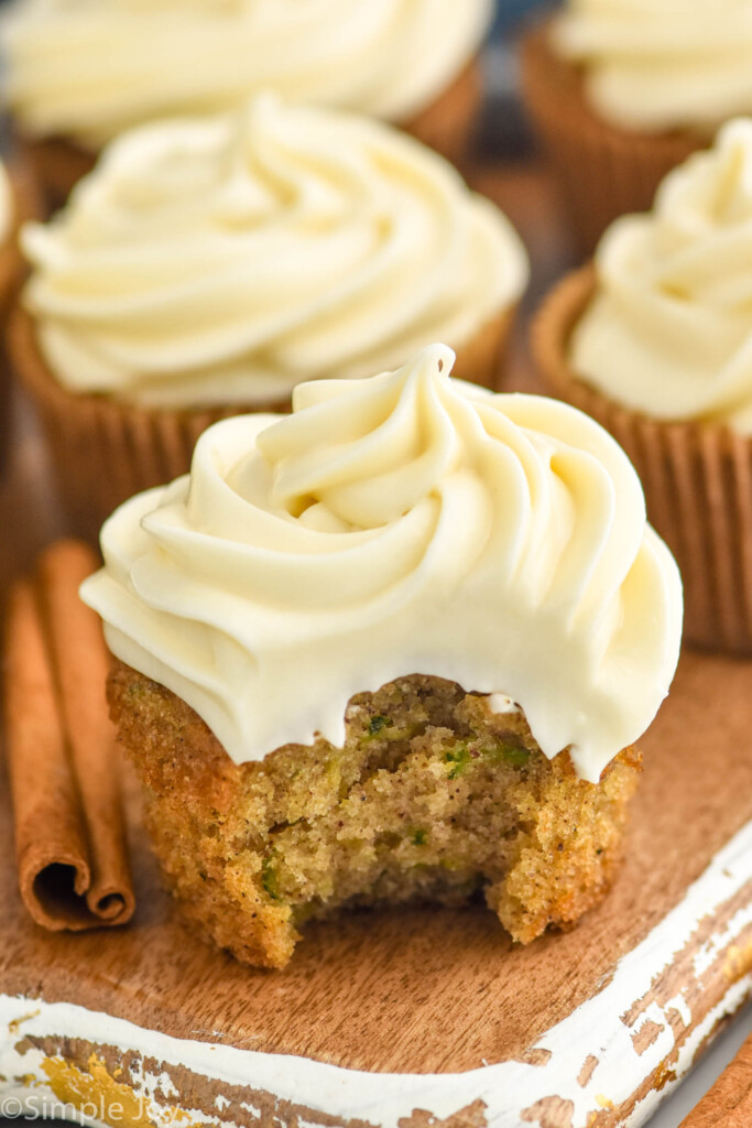 Zucchini Cupcake with bite taken out, topped with cream cheese frosting