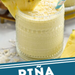 Pinterest graphic for Pina Colada Smoothie, Image shows a glass of Pina Colada Smoothie with two straws, a pineapple wedge, and topped with coconut. Text says "Pina Colada Smoothie simplejoy.com"