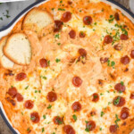 Pinterest graphic for Pizza Dip. Text says "the best Pizza Dip recipe simplejoy.com" Image shows overhead of skillet of Pizza Dip topped with pepperoni and fresh parsley with pieces of toasted baguette.