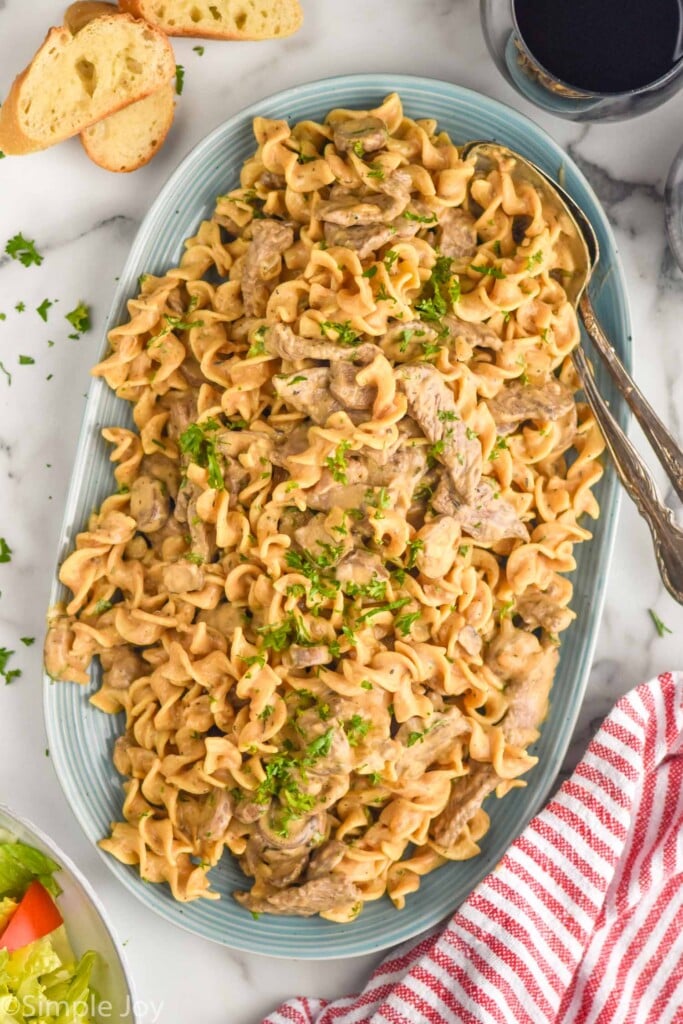 overhead of bowl of Beef Stroganoff with two spoons for serving