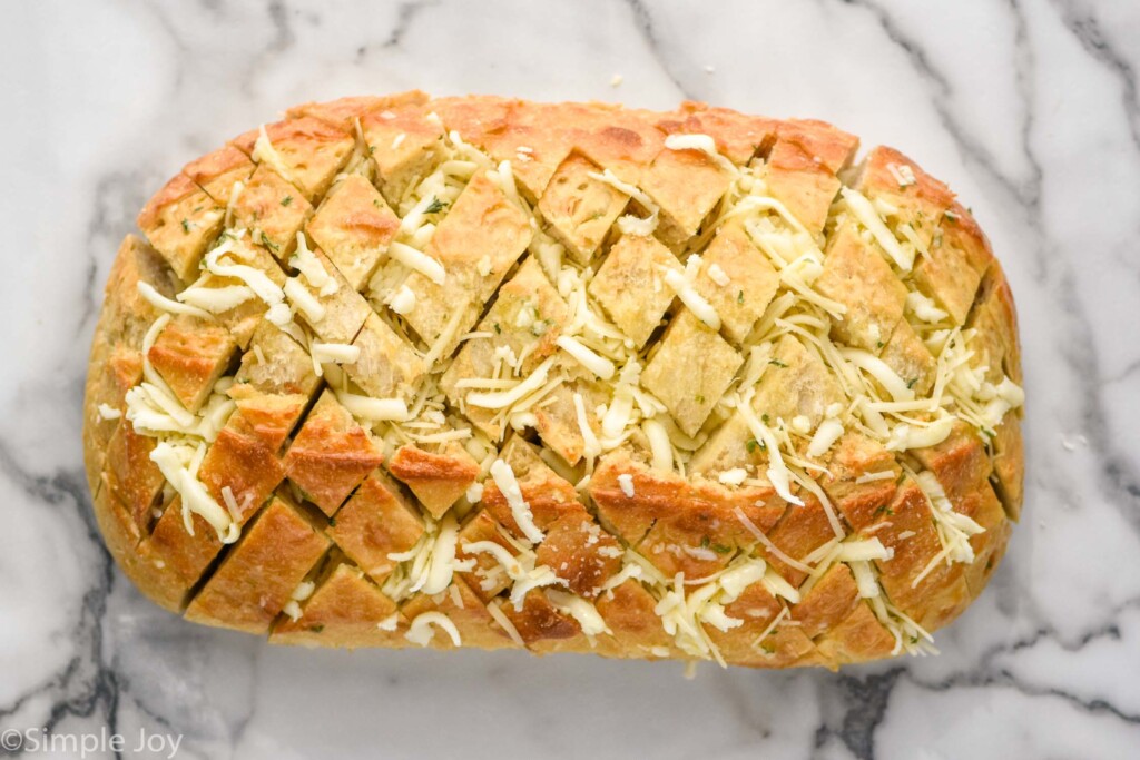 overhead of loaf of Pull Apart Bread with shredded cheese