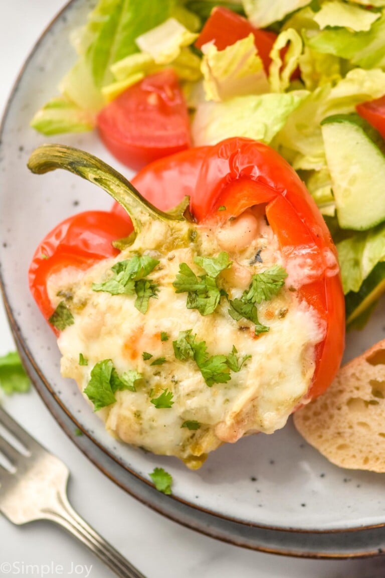 White Chicken Chili Stuffed Pepper topped with parsley on a plate with salad