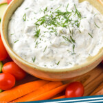 Pinterest graphic for Ranch Dip. Image shows bowl of ranch dip topped with fresh dill surrounded by carrot sticks, cherry tomatoes, and cucumber slices. Text says "ranch dip simplejoy.com"