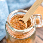 Pinterest graphic for Seasoned Salt. Text says "the best seasoning salt simplejoy.com" Image shows a jar of homemade Seasoned Salt with a wooden spoon for serving