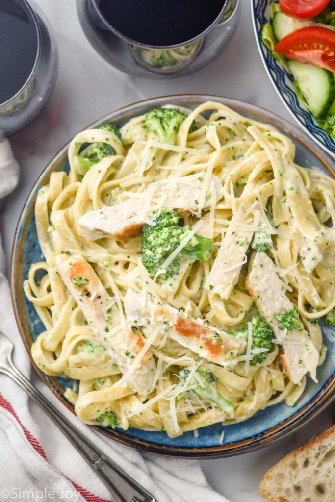 overhead of plate of Chicken Broccoli Alfredo topped with grated parmesan cheese.