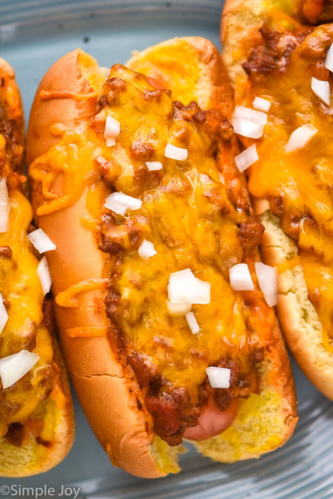 Close up of Chili Dogs topped with diced onions