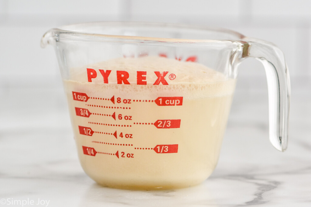 Side view of glass measuring cup of Pizza Dough recipe