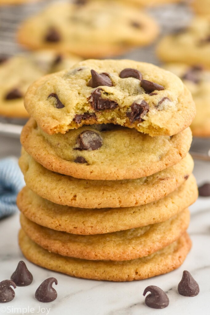 Stack of Chocolate Chip Cookies with chocolate chips sitting in front