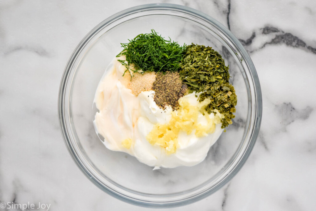 overhead of glass bowl of ranch dip ingredients