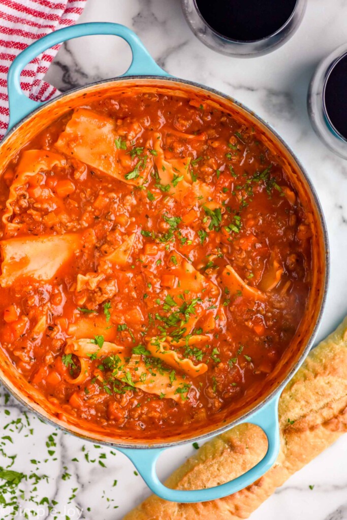 overhead of large soup pot of Lasagna Soup topped with fresh parsley