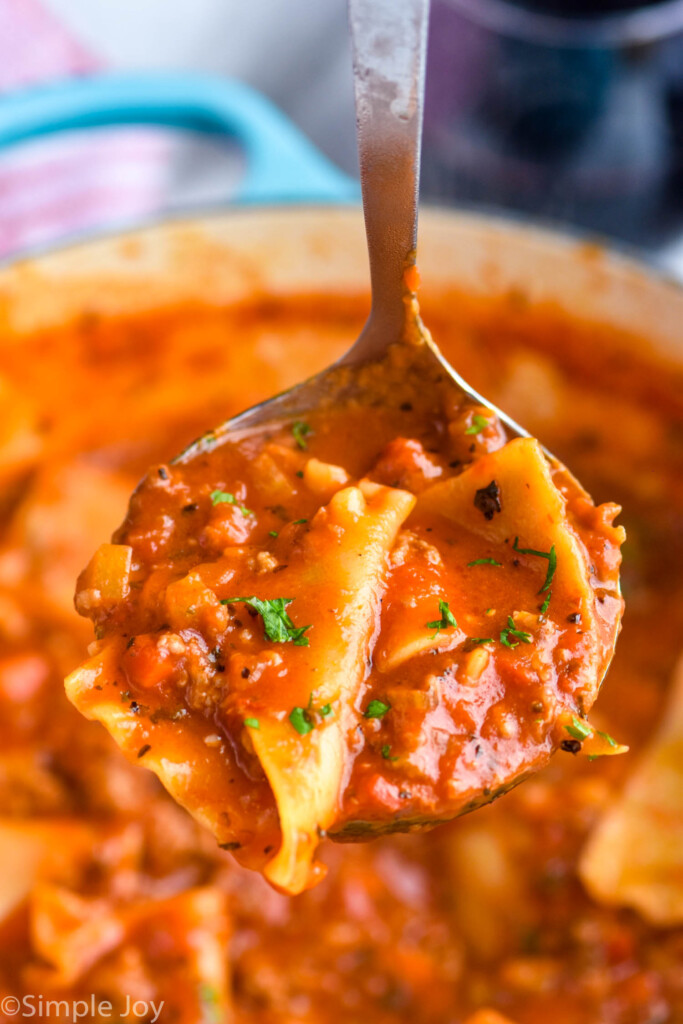 soup ladle holding Lasagna Soup over large pot of Lasagna Soup