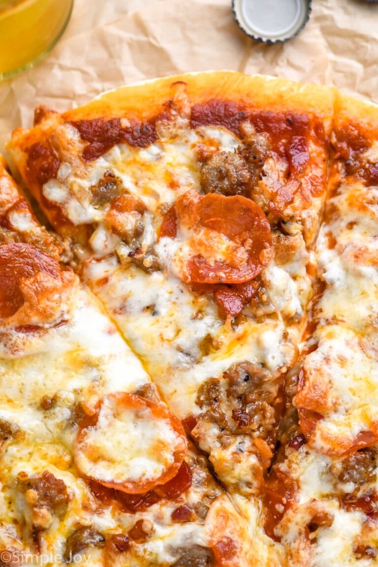 close up of slice cut into Meat Lovers Pizza