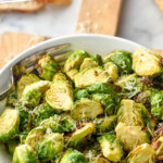 Pinterest graphic for Air Fryer Brussels Sprouts. Text says "air fryer brussel sprouts simplejoy.com" Image shows a bowl of Air Fryer Brussels Sprouts topped with parmesan cheese