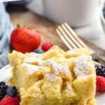 Pinterest graphic for Crockpot French Toast. Says "slow cooker french toast simplejoy.com" Image shows a piece of Crockpot French Toast dusted with powdered sugar on a plat with fresh berries