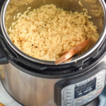 pinterest graphic for Instant Pot Risotto. Image shows instant pot with risotto and wooden spoon inside. Text says "the best Instant Pot Risotto simplejoy.com"