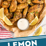 Pinterest graphic for lemon pepper wings. Image shows overhead of basket of Lemon Pepper Wings with lemon wedges and small cup of dipping sauce. Text says "Lemon Pepper Wings simplejoy.com"