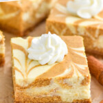 Pinterest graphic for Pumpkin Cheesecake Bars. Text says "Pumpkin Cheesecake Bars simplejoy.com" Image shows close up of a Pumpkin Cheesecake Bar with piped whipped cream