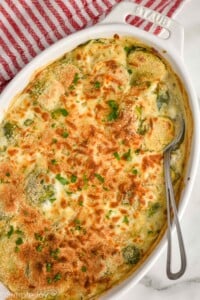 overhead of a Brussel sprout casserole with a spoon in the dish