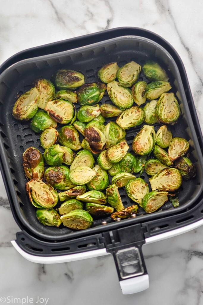 overhead of air fryer basket of cooked Air Fryer Brussels Sprouts