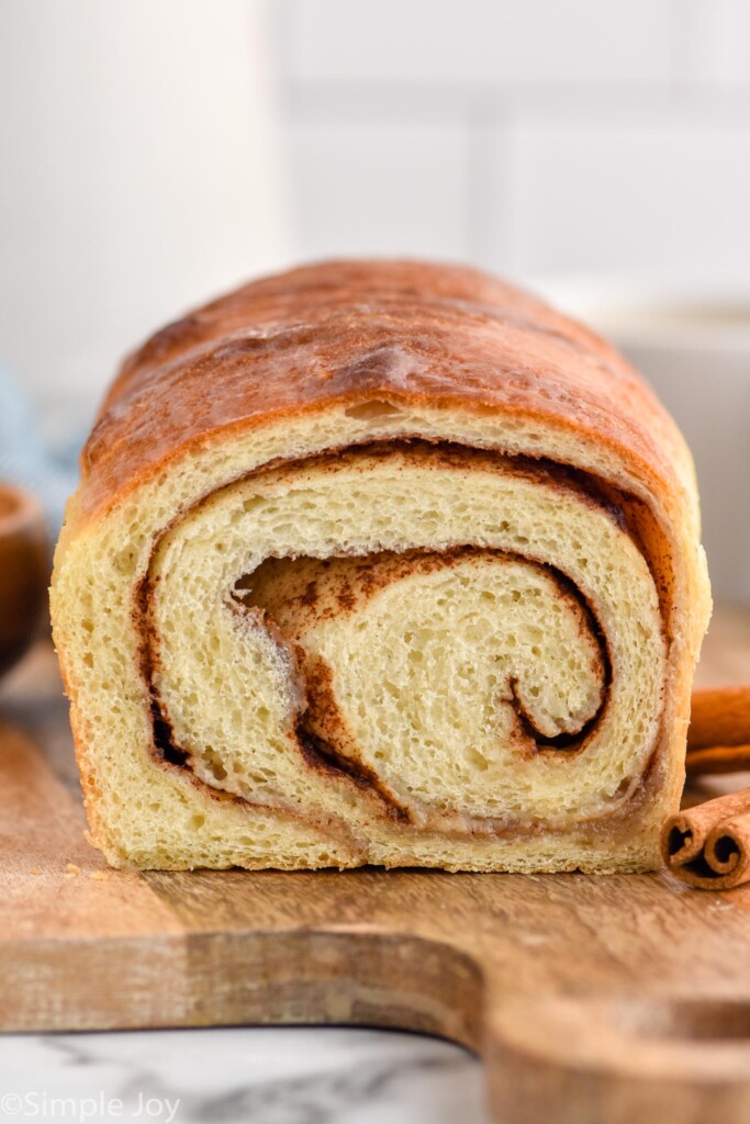 inside of loaf of cinnamon bread sitting on a wooden board for serving