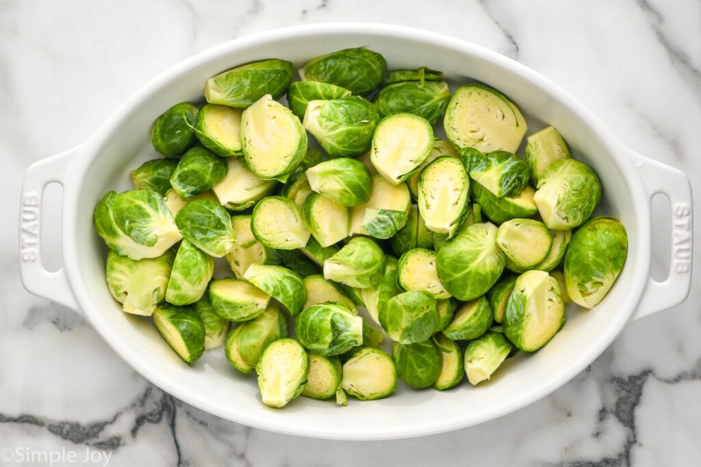 overhead of casserole dish of sliced brussels sprouts to make Brussels Sprouts Casserole