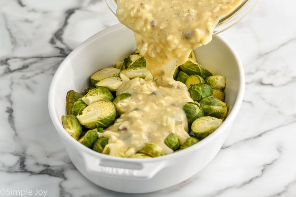 creamy soup mixture being poured over Brussel sprouts