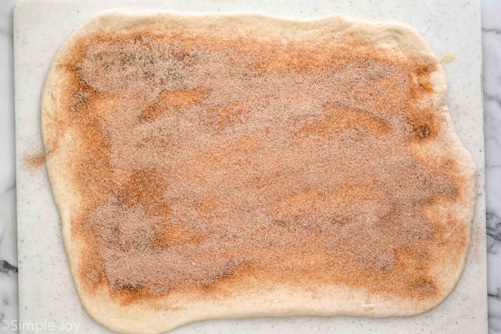 overhead of Cinnamon Bread dough rolled out with cinnamon sugar mixture on top