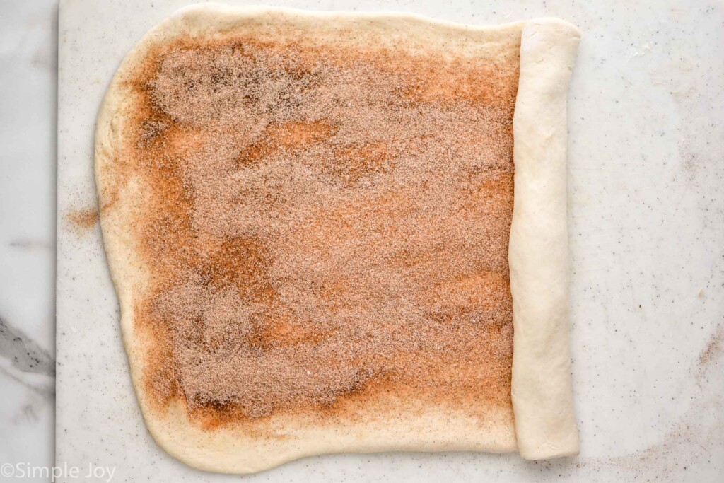 overhead of Cinnamon Bread dough rolled out with cinnamon sugar mixture on top