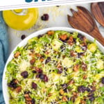 Pinterest graphic for Brussels Sprout Salad. Text says "the best Brussels Sprout Salad simplejoy.com" Image shows overhead of bowl of Brussels Sprout Salad topped with shredded parmesan cheese.