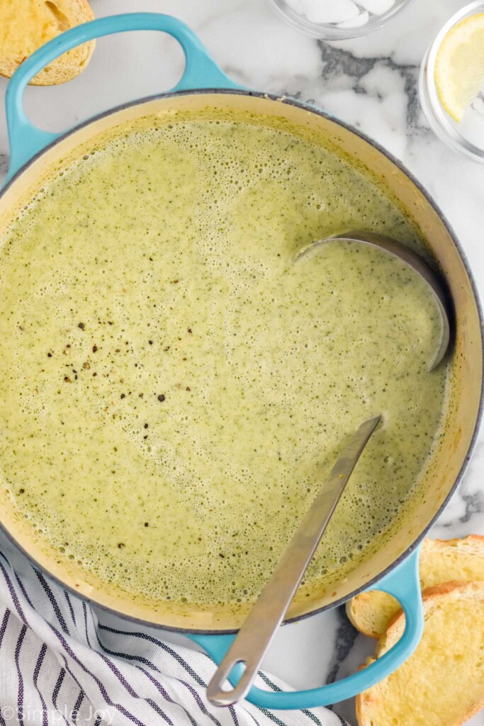 overhead of large pot of Cream of Broccoli Soup with a ladle