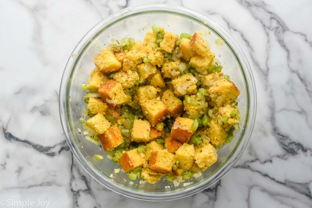 Overhead of glass bowl of Cornbread Stuffing ingredients