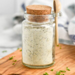 Jar of Homemade Ranch Seasoning with a lid and small wooden spoon.