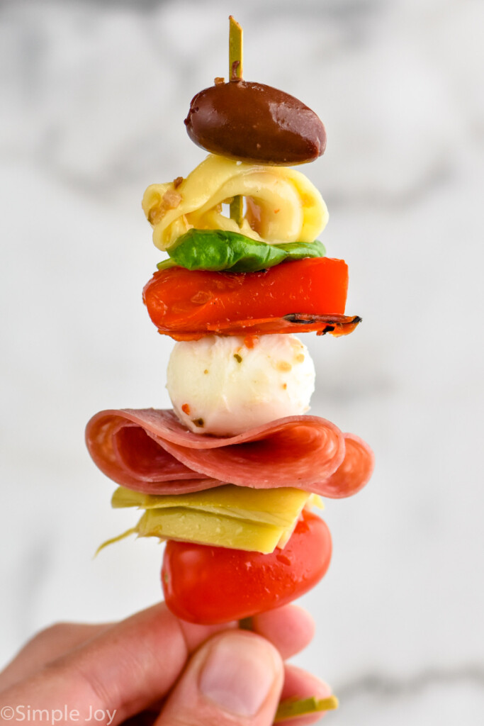 person's hand holding Antipasto Skewer