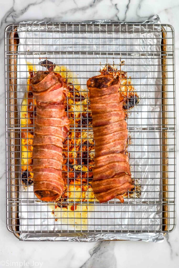 Overhead view of Bacon Wrapped Pork Tenderloin on a wire rack on a baking sheet after baking.