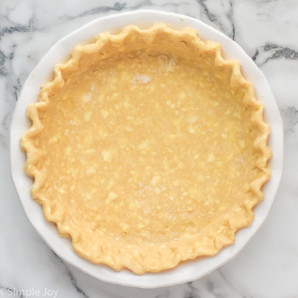 overhead of pie crust in pie plate to make quiche