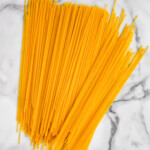 overhead of dry spaghetti sitting on the counter