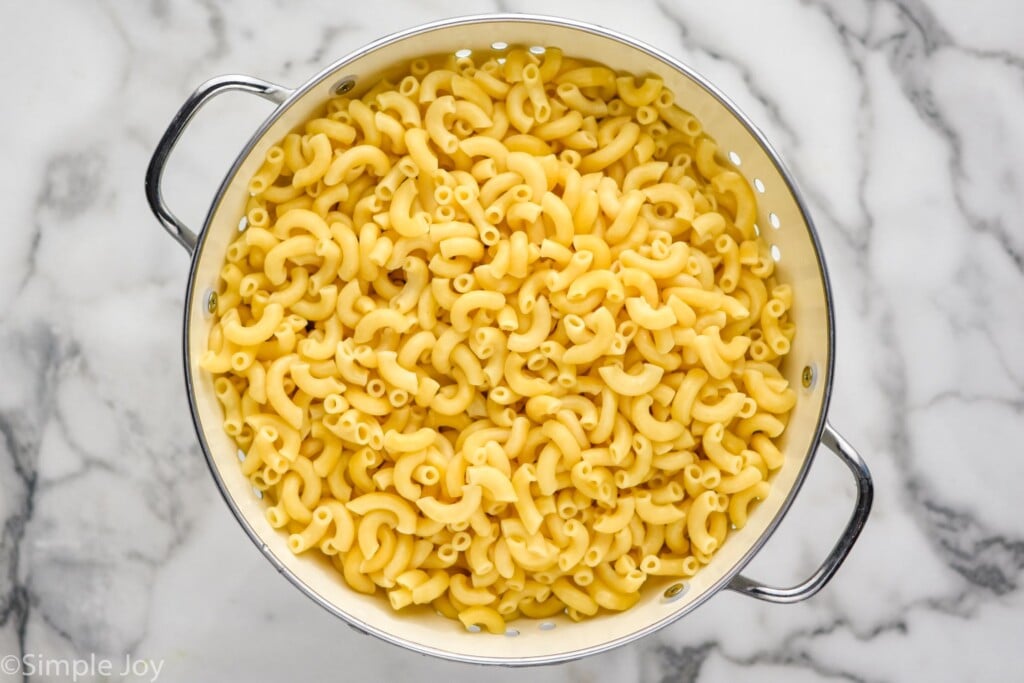 overhead of elbow macaroni in a colander