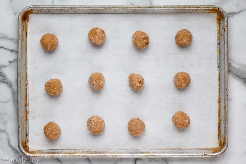 overhead of brown sugar cookie dough balls on a parchment-lined baking sheet