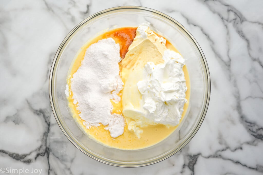 Overhead of glass bowl with ingredients to make Eggnog Pie