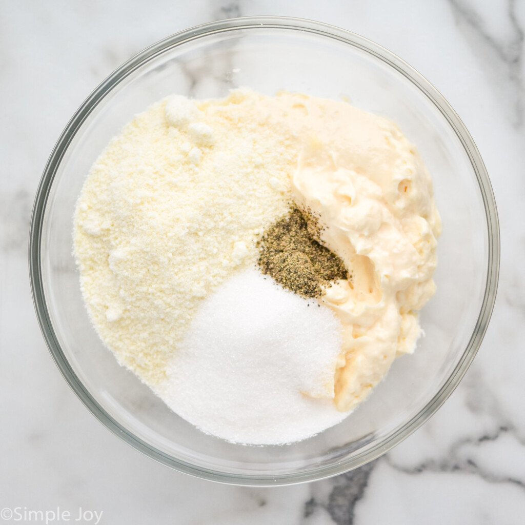 overhead of bowl of seven layer salad dressing ingredients