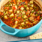 Pinterest graphic for Vegetable Beef Soup. Image shows a pot of Vegetable Beef Soup with a soup ladle. Text says "Vegetable Beef Soup simplejoy.com"